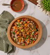 Chicken-Glazed Beef bowl: fresh dog food with beef, zucchini, carrots and peas in a wooden bowl